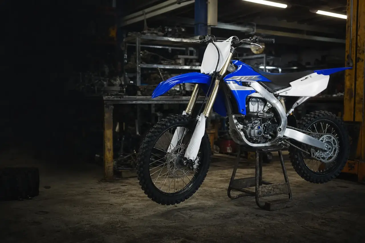 late-model Yamaha YZ450F-style motocross bike being inspected in an Australian wrecker workshop